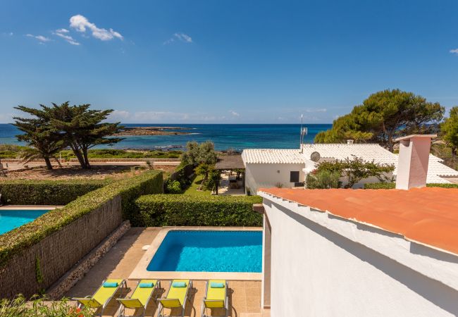 Swimming pool of the Villa Binillor de Binisafuller with the coast in the background, just a few metres from the accommodation.