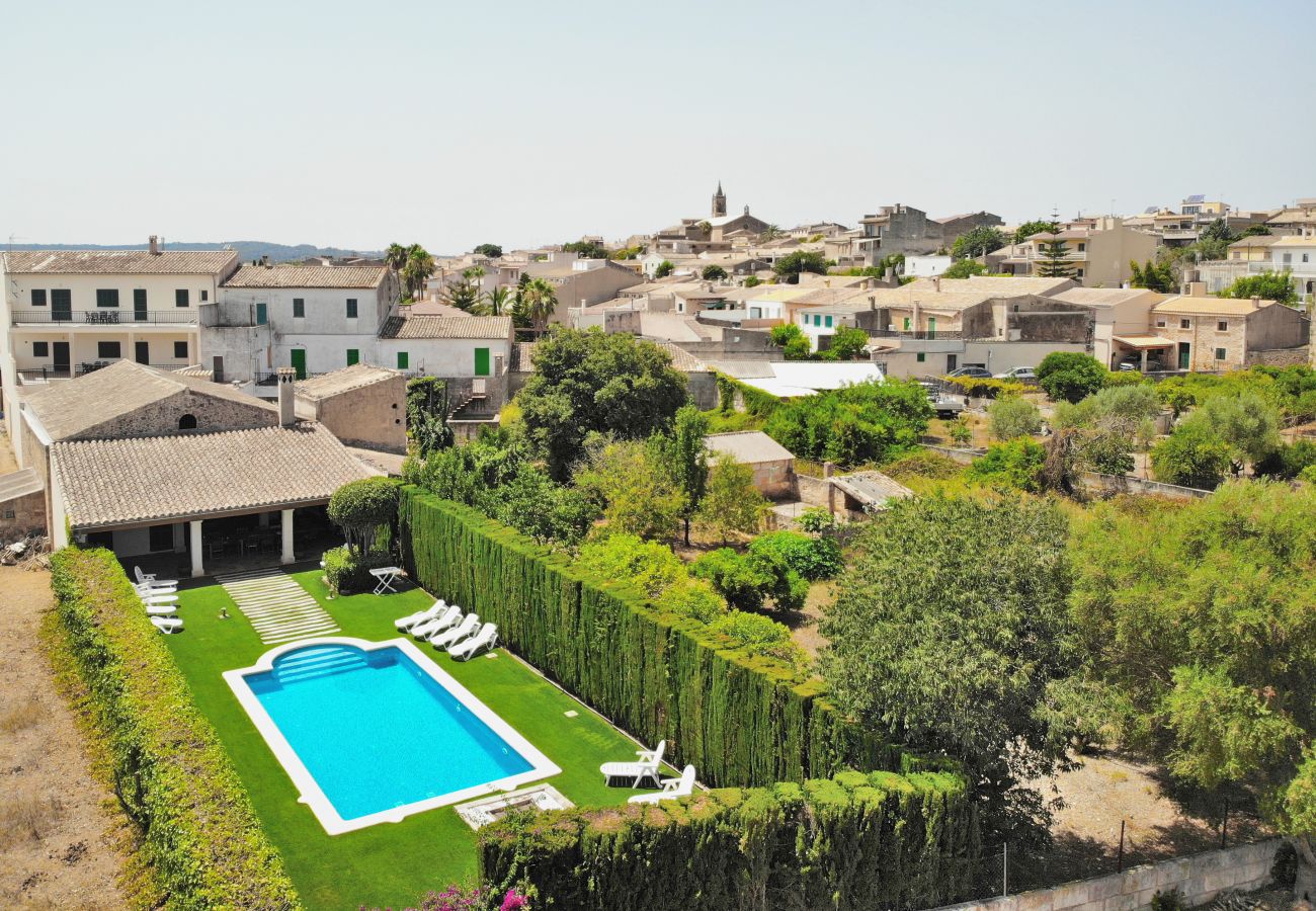 Views of the swimming pool of the villa Tofollubi with the village of Llubi.